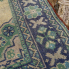 Close-up of the pale blue Turkish large vintage rug showing traditional details, hand-knotted weave, wool and cotton and low pile.