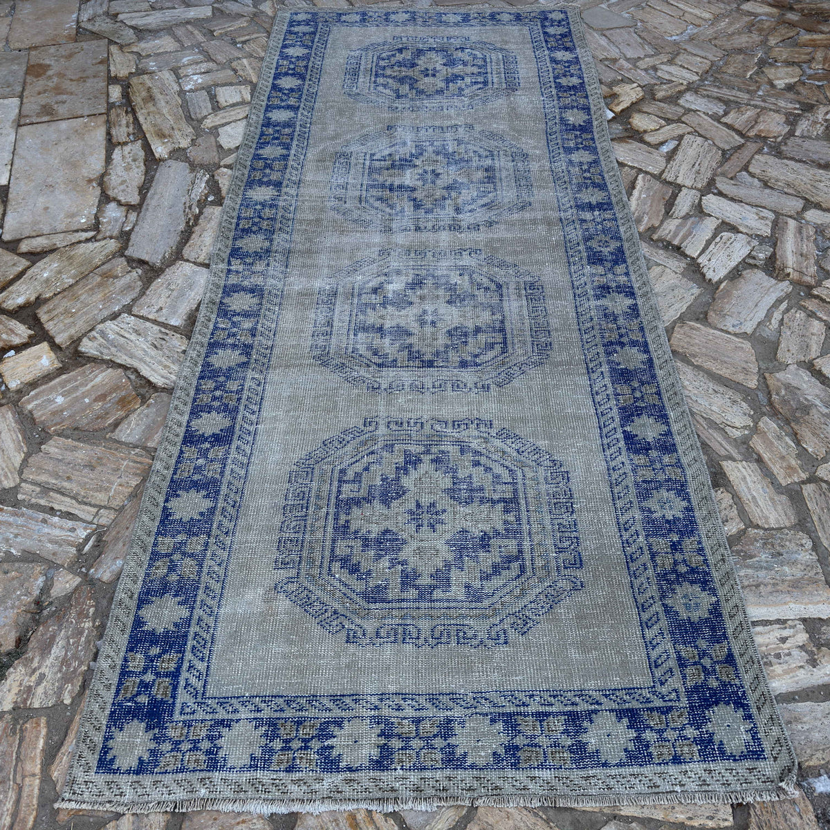 Blue 5' x 11' Turkish large vintage rug in wool and cotton, shown on the floor.