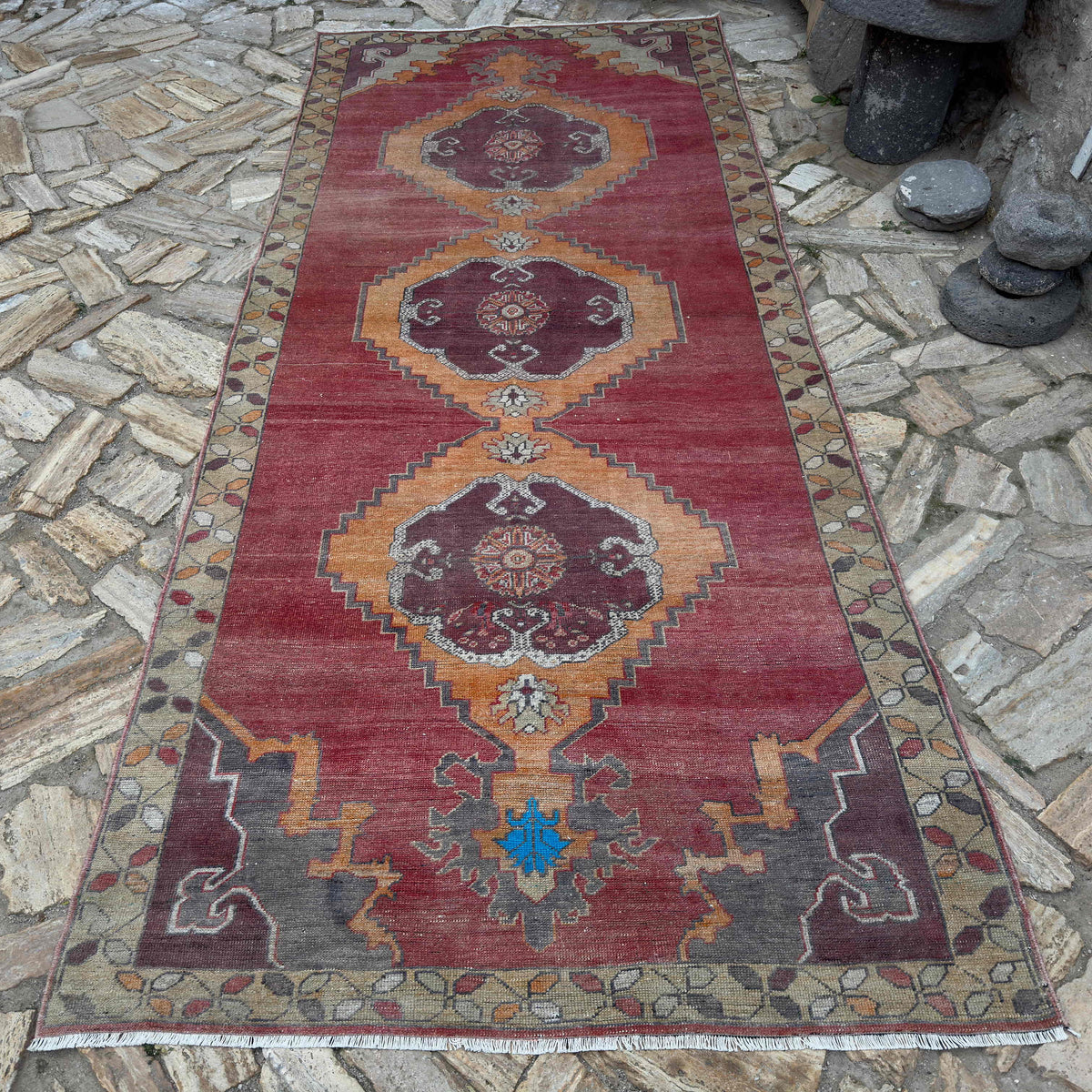 Pale Red 5' x 11' Turkish large vintage rug in wool and cotton, shown on the floor.