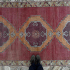 1970s pale red Turkish large vintage rug with traditional design, hand-knotted weave and low pile.