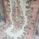 Pink 6' x 10' Turkish large vintage rug in wool and cotton, shown on the floor.