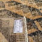 Close-up of the orange Turkish large vintage rug showing traditional details, hand-knotted weave, wool and cotton and low pile.