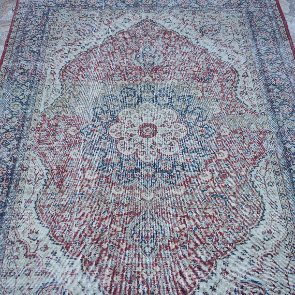 Close-up of the red Turkish large vintage rug showing traditional details, hand-knotted weave, wool and cotton and low pile.