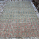 Pink 7' x 11' large vintage turkish rug in wool and cotton, shown on the floor.