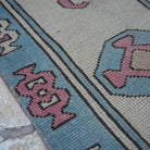 Pale Pink 7' x 10' Turkish large wool rug in wool, shown on the floor.