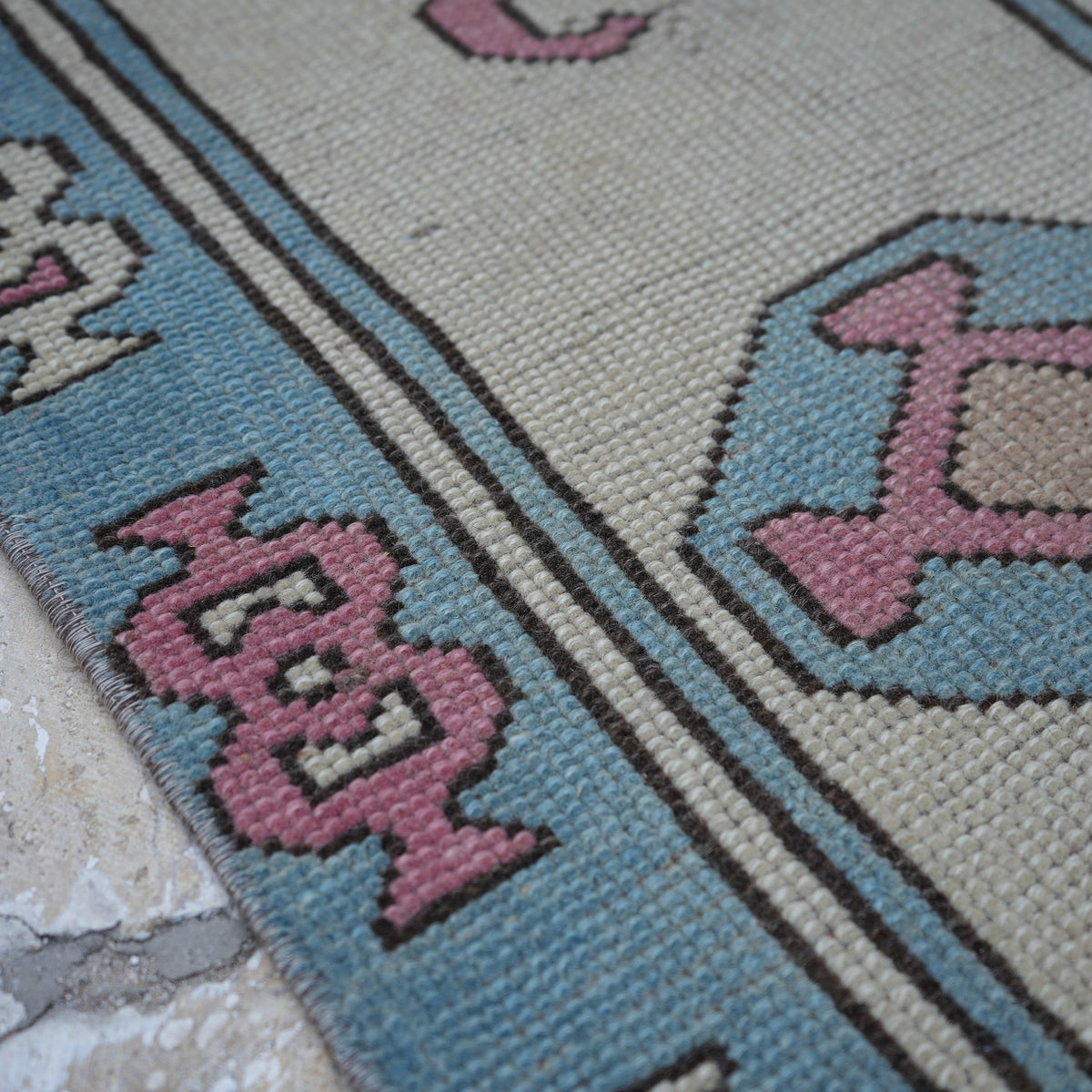 Pale Pink 7' x 10' Turkish large wool rug in wool, shown on the floor.