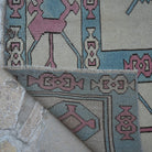 1970s pale pink Turkish large wool rug with geometric design, hand-knotted weave and low pile.