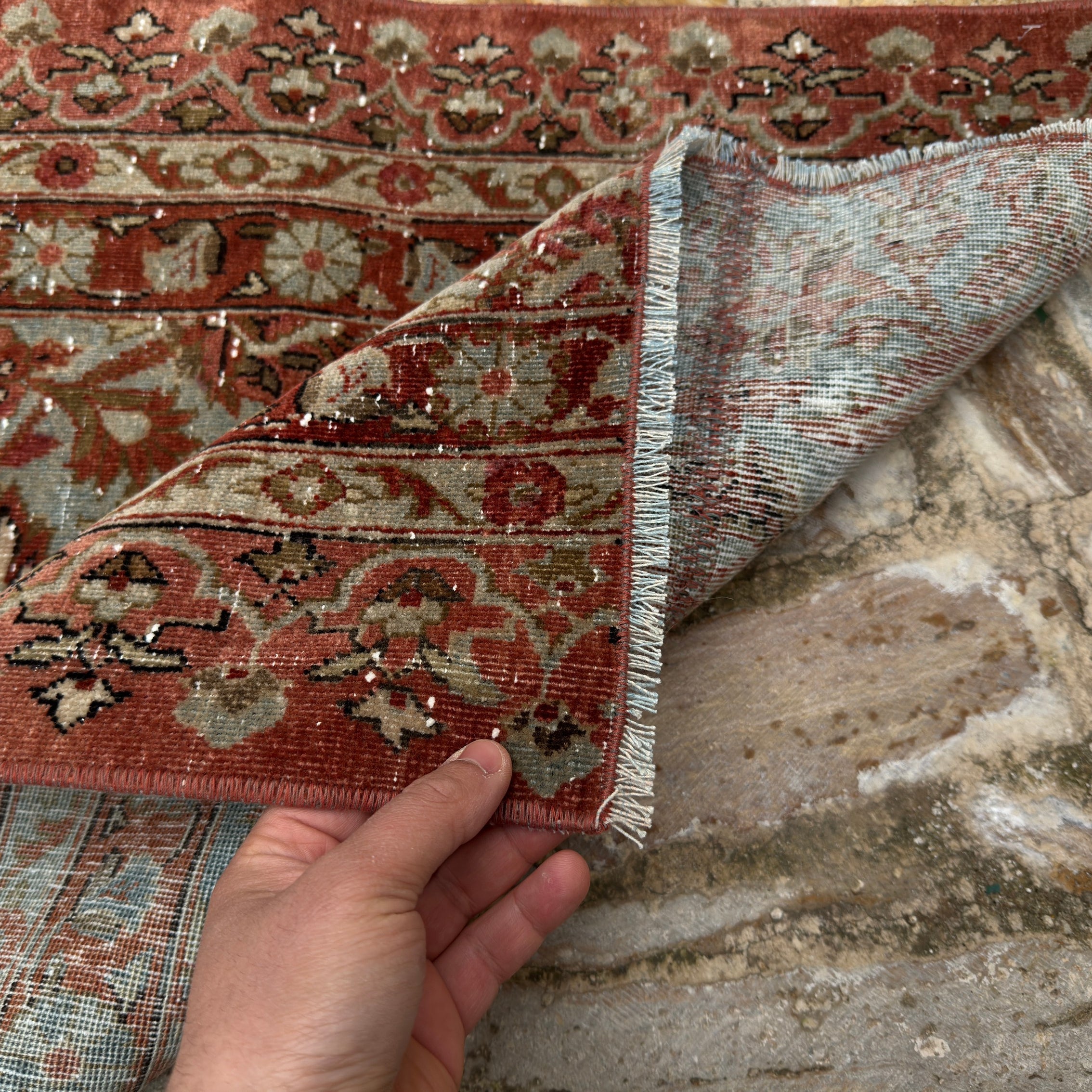 Close-up of the brown long persian runner rug showing patchwork details, hand-knotted weave, wool and cotton and low pile.