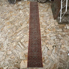 Brown 2' x 15' long persian runner rug in wool and cotton, shown on the floor.