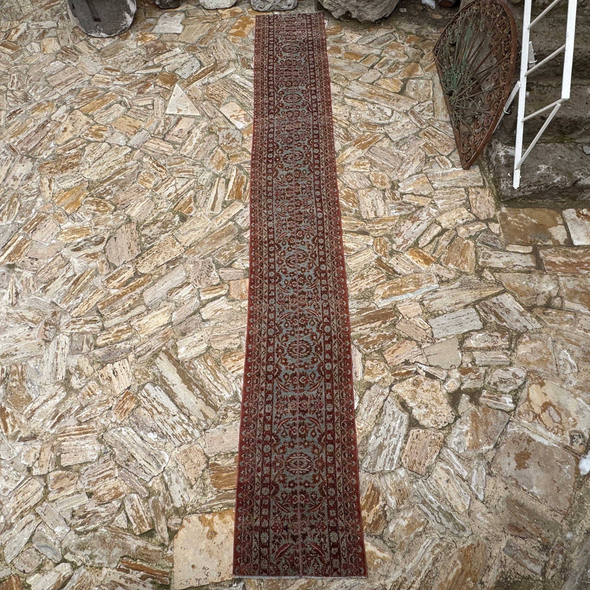 Brown 2' x 15' long persian runner rug in wool and cotton, shown on the floor.