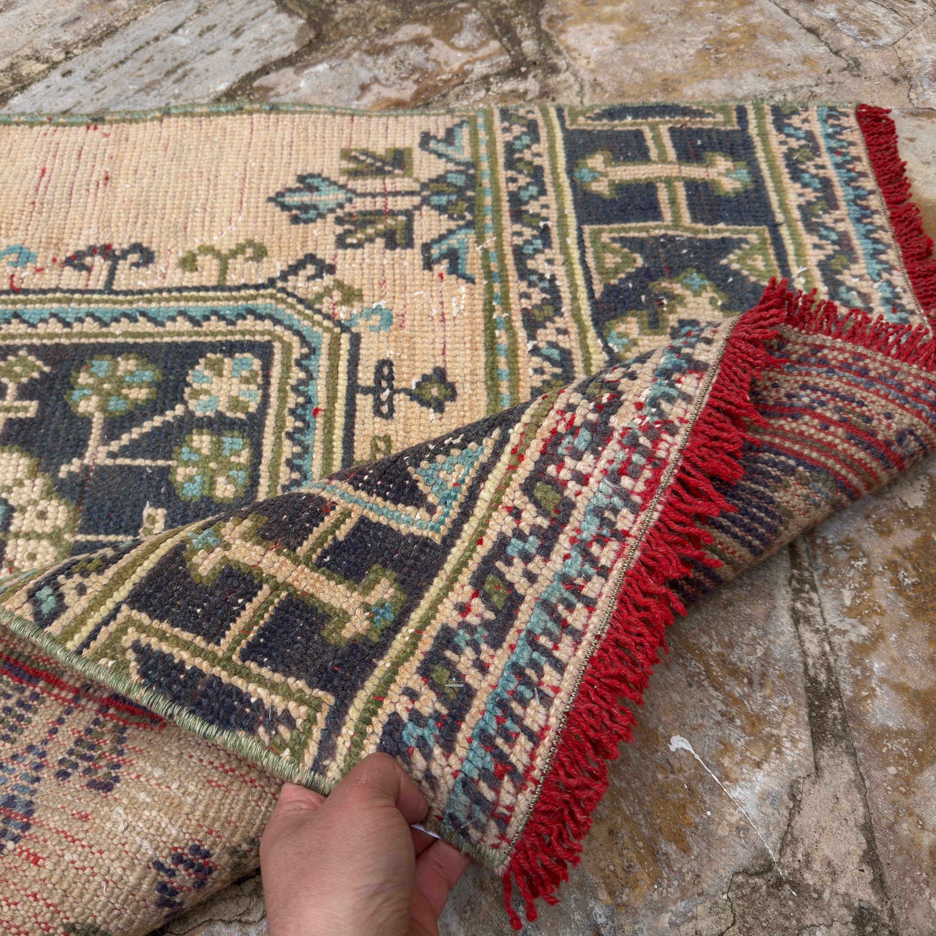 Close-up of the beige Turkish long vintage runner rug showing geometric details, hand-knotted weave, wool and low pile.