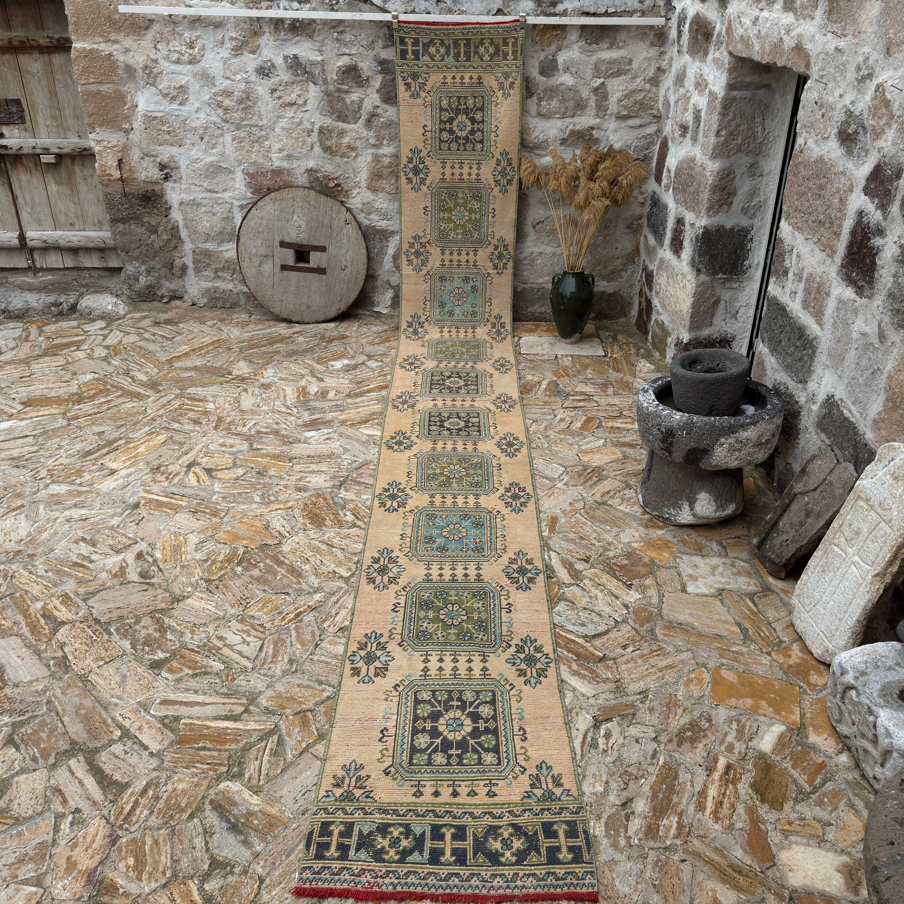 Beige 3' x 21' Turkish long vintage runner rug in wool, shown on the floor.