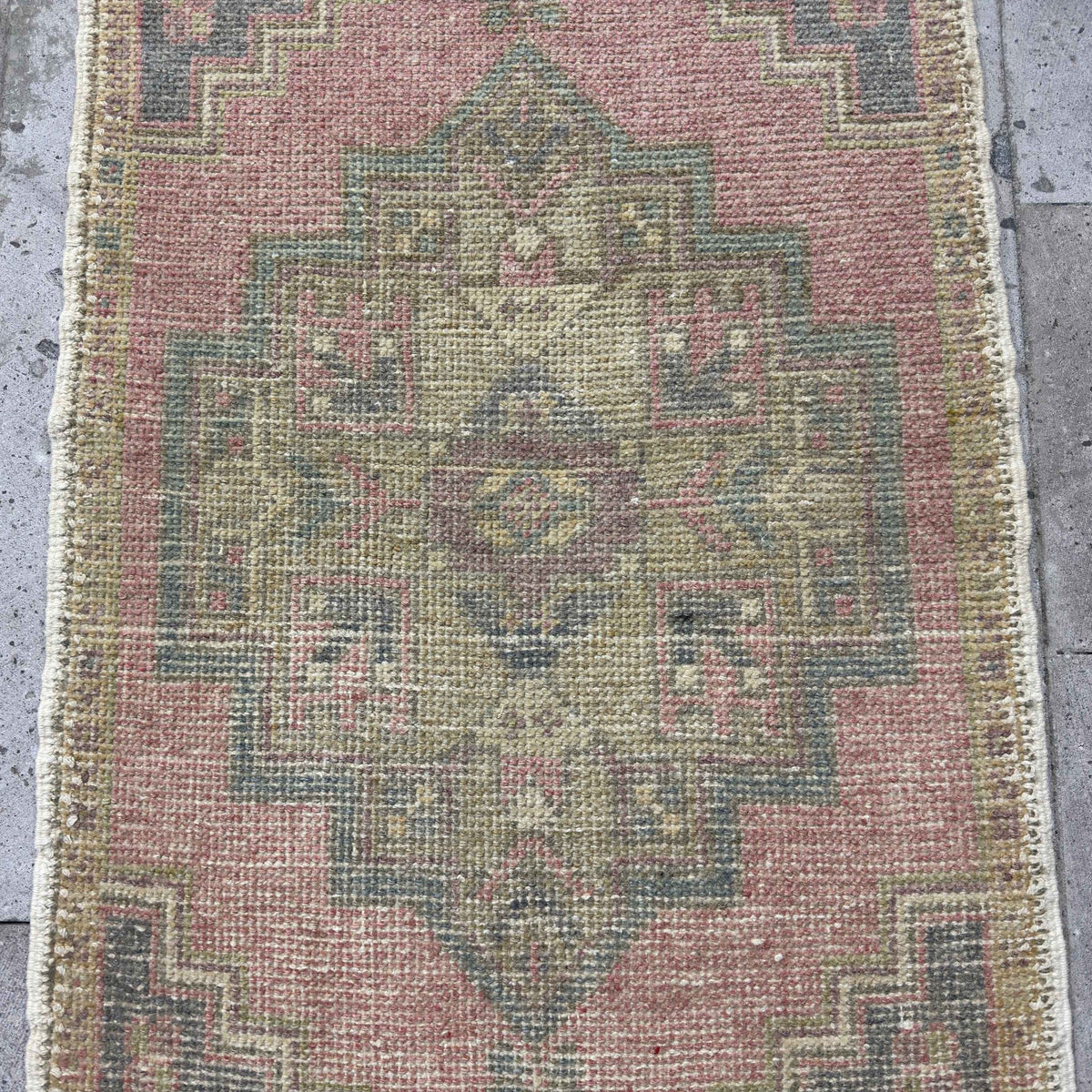 1970s pink Turkish mini anatolian rug with traditional design, hand-knotted weave and low pile.