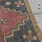 Close-up of the red Turkish mini anatolian rug showing traditional details, hand-knotted weave, wool and cotton and low pile.