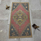 Red 2' x 3' Turkish mini anatolian rug in wool and cotton, shown on the floor.