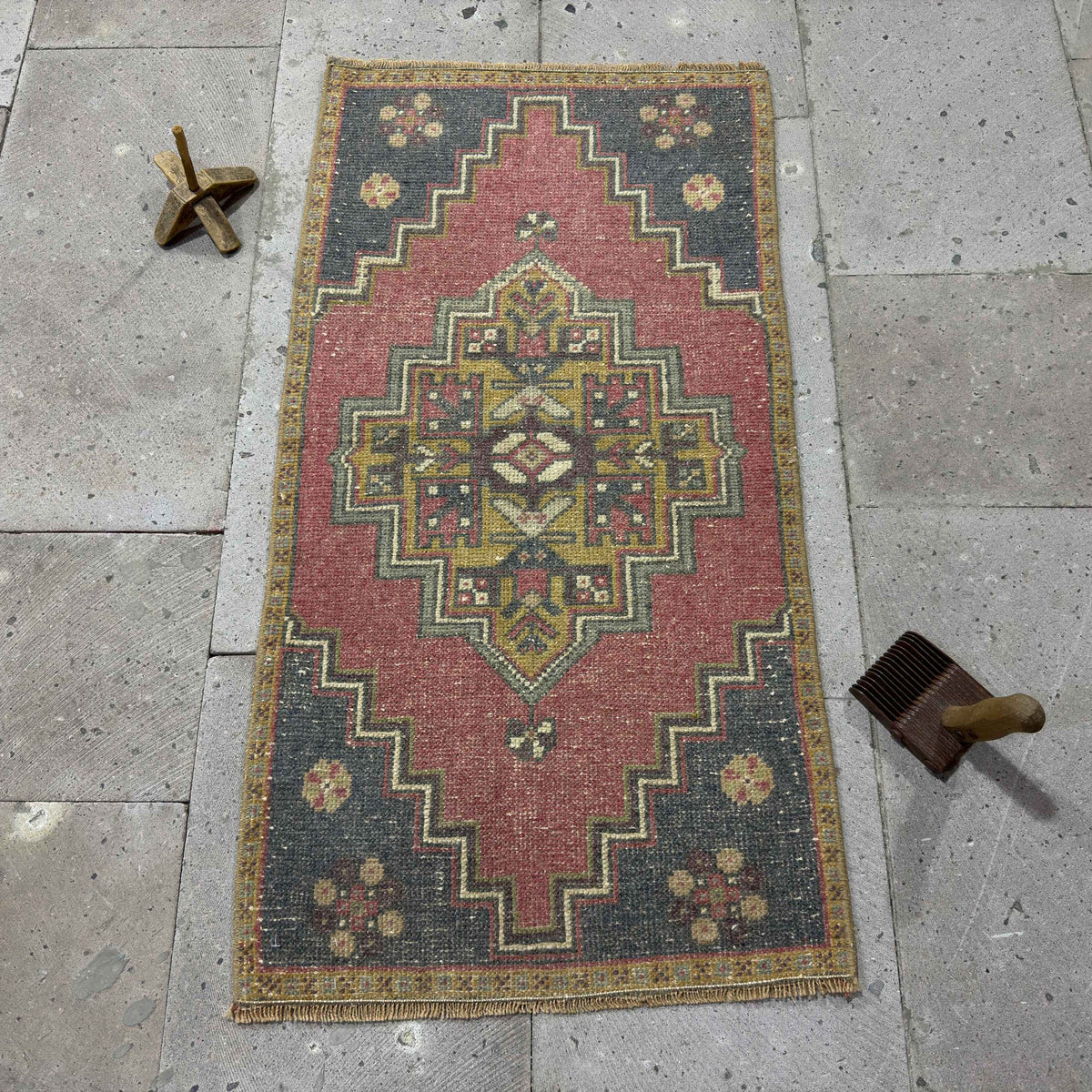 Red 2' x 3' Turkish mini anatolian rug in wool and cotton, shown on the floor.
