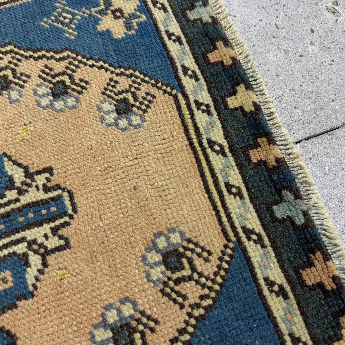 Close-up of the blue Turkish mini runner rug showing traditional details, hand-knotted weave, wool and cotton and low pile.