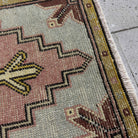 Close-up of the pink mini turkish carpet showing medallion details, hand-knotted weave, wool and cotton and low pile.