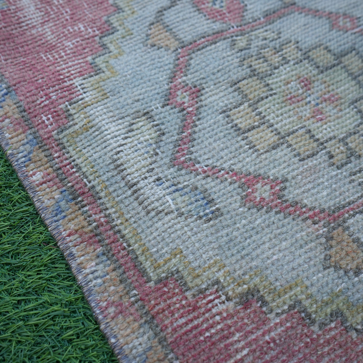 Red 1' x 3' mini turkish rug in wool and cotton, shown on the floor.