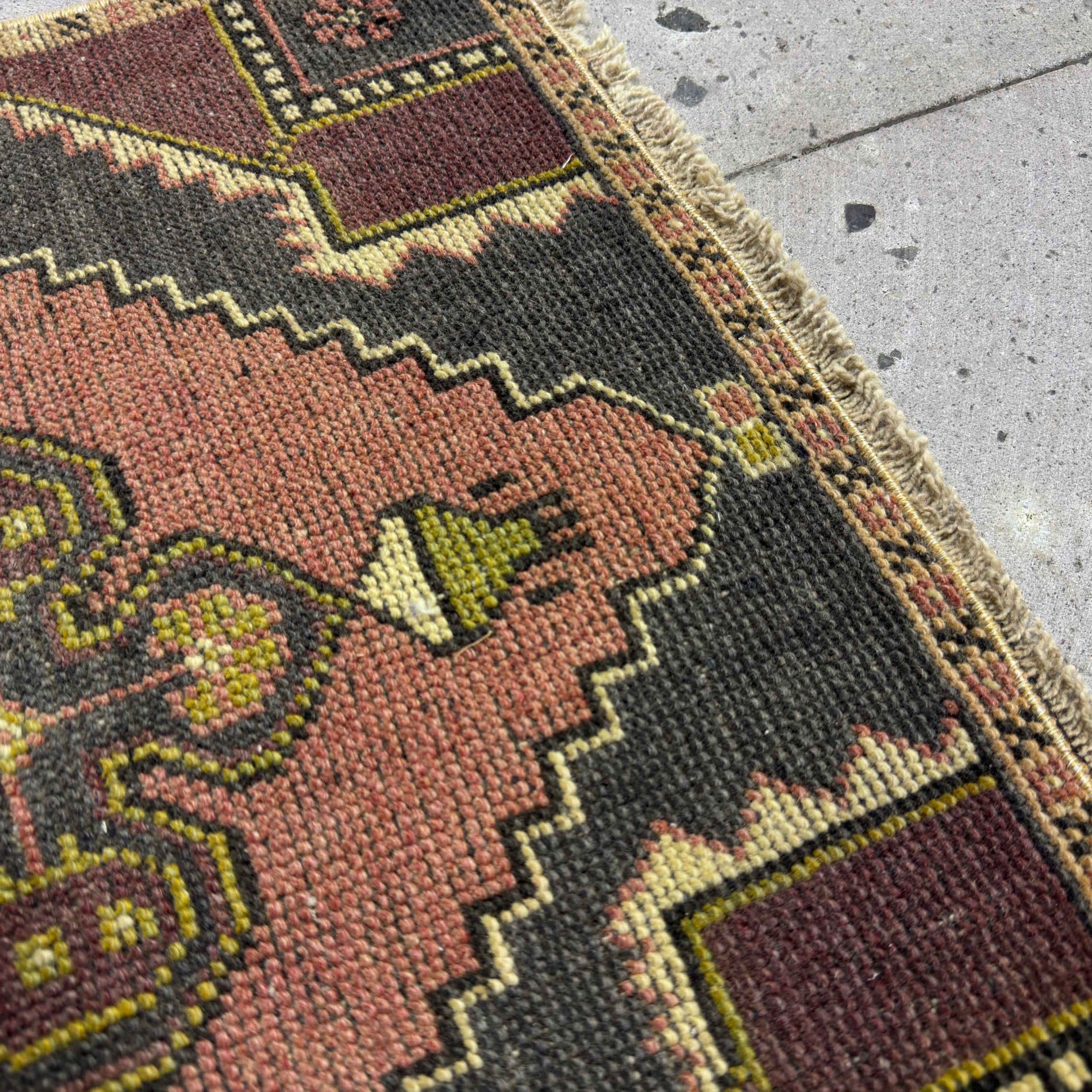 Close-up of the purple mini turkish rug showing traditional details, hand-knotted weave, wool and cotton and low pile.