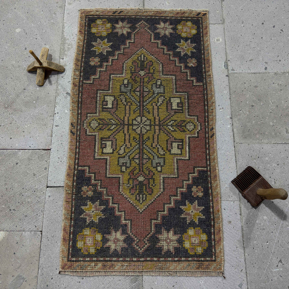 Red 2' x 3' mini turkish rug in wool and cotton, shown on the floor.