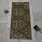 Brown 1' x 3' Turkish mini vintage rug in wool and cotton, shown on the floor.