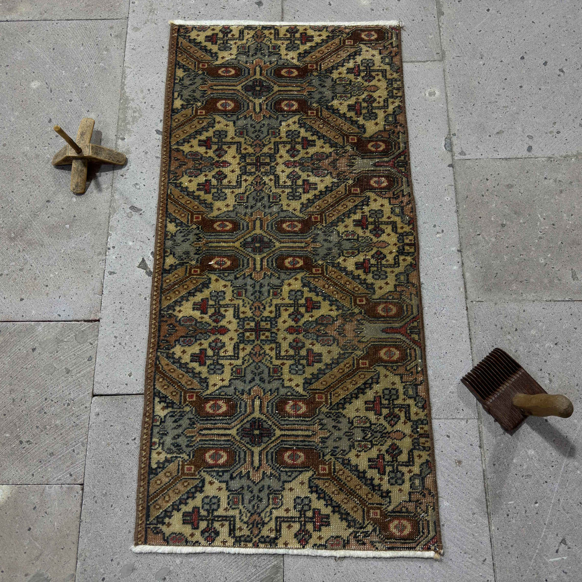 Brown 1' x 3' Turkish mini vintage rug in wool and cotton, shown on the floor.