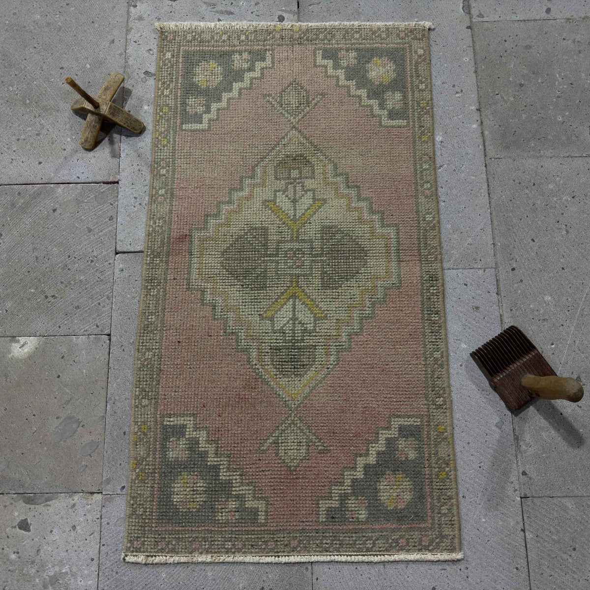 Pink 1' x 3' Turkish mini vintage rug in wool and cotton, shown on the floor.