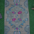 Close-up of the beige Turkish mini vintage rug showing traditional details, hand-knotted weave, wool and cotton and low pile.