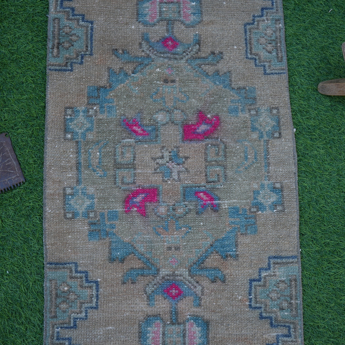 Close-up of the beige Turkish mini vintage rug showing traditional details, hand-knotted weave, wool and cotton and low pile.