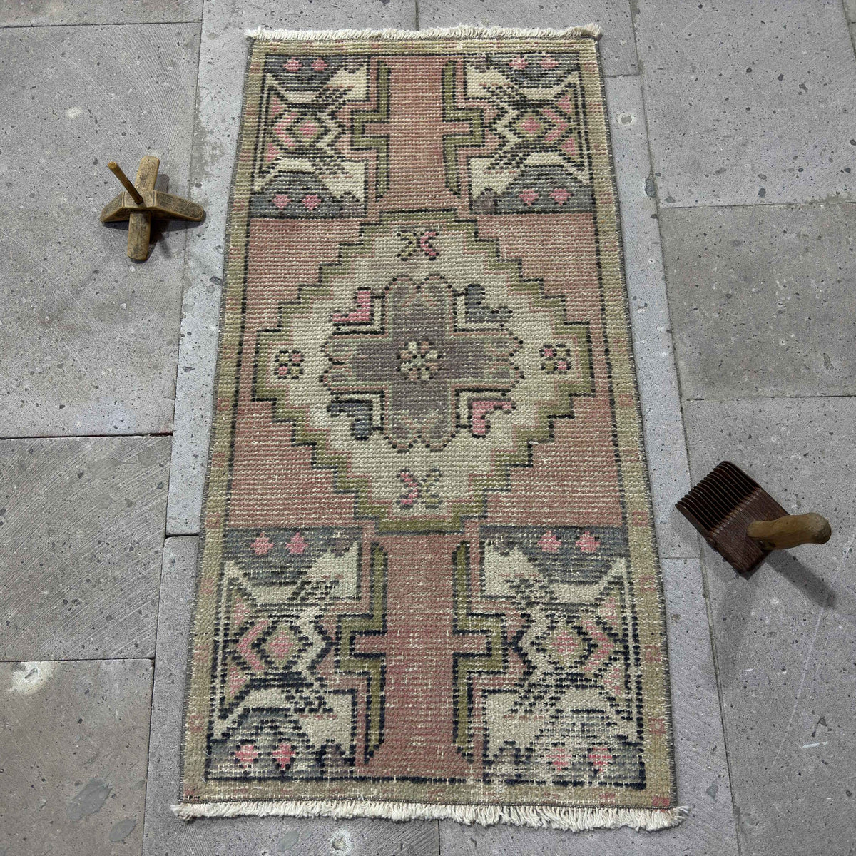 Pink 2' x 3' Turkish mini vintage rug in wool and cotton, shown on the floor.