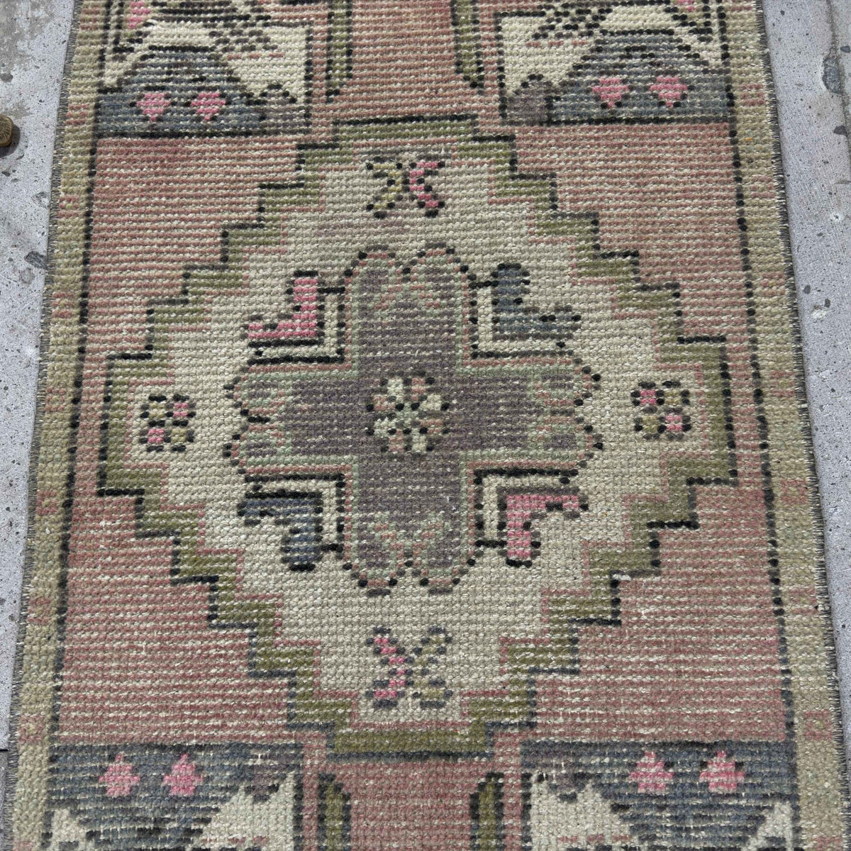 1970s pink Turkish mini vintage rug with traditional design, hand-knotted weave and low pile.