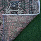 1970s pink Turkish mini vintage rug with traditional design, hand-knotted weave and low pile.