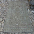Beige 4' x 8' Turkish muted vintage rug in wool and cotton, shown on the floor.