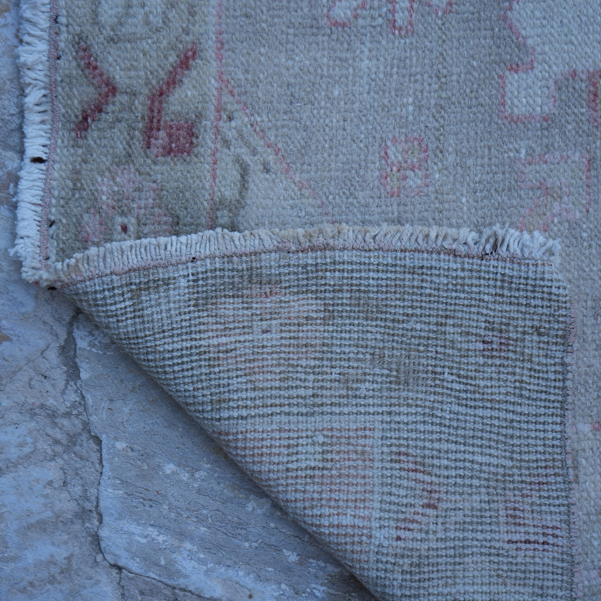 1970s pale red neutral turkish rug with neutral design, hand-knotted weave and low pile.