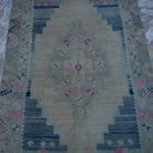 Close-up of the beige Turkish neutral vintage rug showing neutral details, hand-knotted weave, wool and low pile.