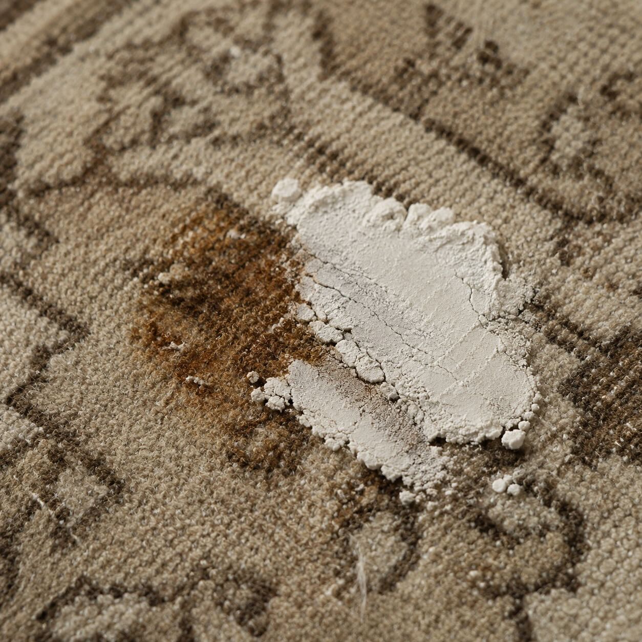 Baking soda paste applied to an old, set-in rust stain on a distressed vintage wool rug