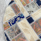 Close-up of the beige Turkish oriental wool rug showing patchwork details, hand-knotted weave, wool and cotton and low pile.