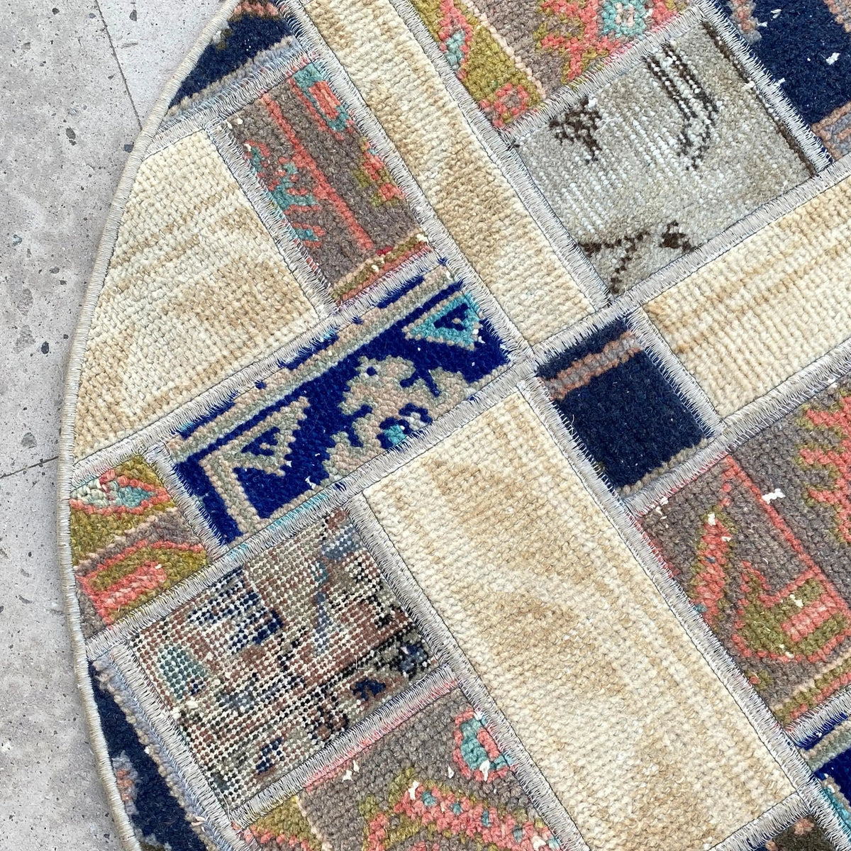 Close-up of the beige Turkish oriental wool rug showing patchwork details, hand-knotted weave, wool and cotton and low pile.