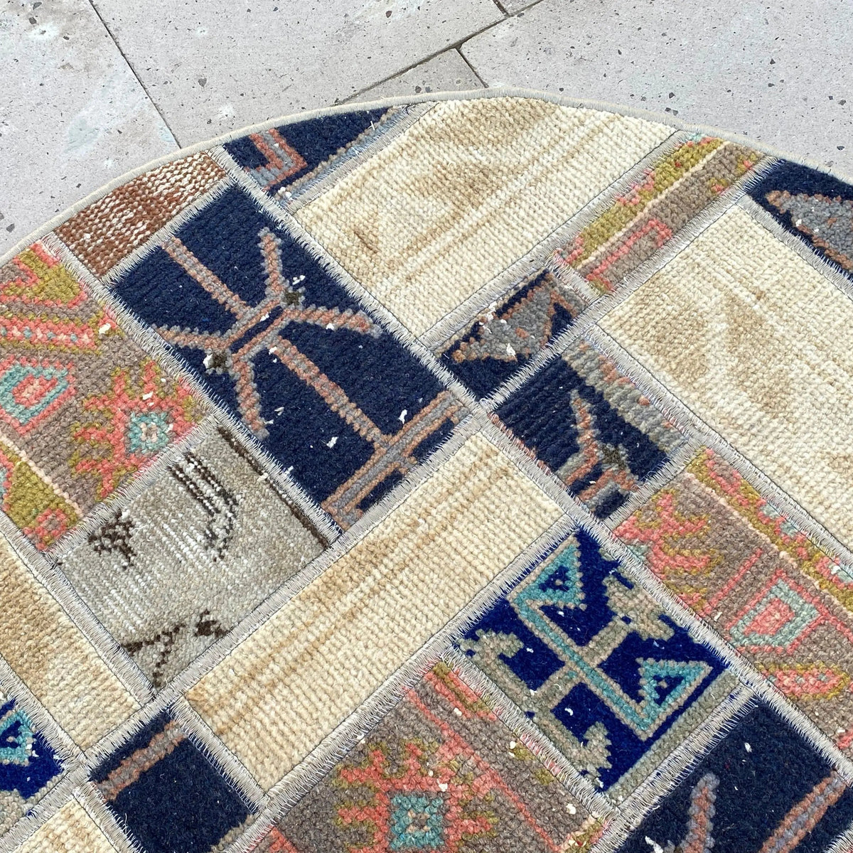1970s beige Turkish oriental wool rug with patchwork design, hand-knotted weave and low pile.