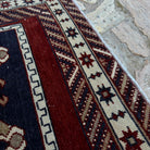 Close-up of the blue Turkish oriental wool rug showing traditional details, hand-knotted weave, wool and cotton and low pile.