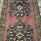 Pink 4' x 10' Turkish oriental wool rug in wool and cotton, shown on the floor.