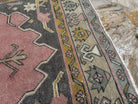 1970s pink Turkish oriental wool rug with geometric design, hand-knotted weave and low pile.
