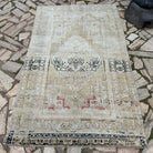 Beige 4' x 7' Turkish oriental wool rug in wool and cotton, shown on the floor.