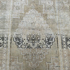 1970s beige Turkish oriental wool rug with neutral design, hand-knotted weave and low pile.