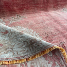 Close-up of the red Turkish oriental wool rug showing medallion details, hand-knotted weave, wool and cotton and low pile.