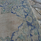 Close-up of the blue Turkish oriental wool rug showing medallion details, hand-knotted weave, wool and cotton and low pile.