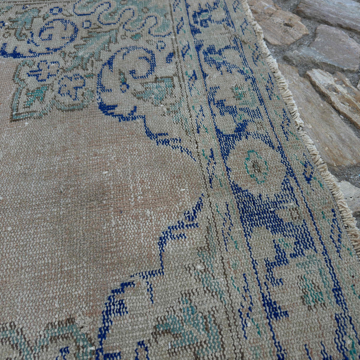 Close-up of the blue Turkish oriental wool rug showing medallion details, hand-knotted weave, wool and cotton and low pile.