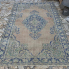 Blue 6' x 9' Turkish oriental wool rug in wool and cotton, shown on the floor.