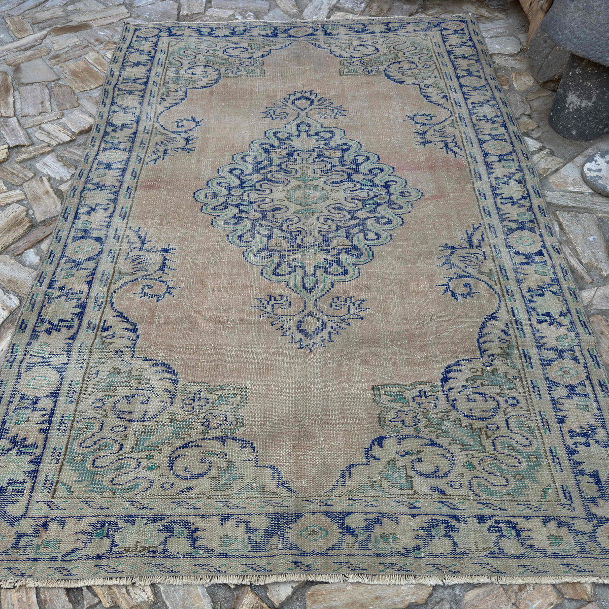 Blue 6' x 9' Turkish oriental wool rug in wool and cotton, shown on the floor.